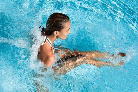 Woman Playing in Pool with Jets